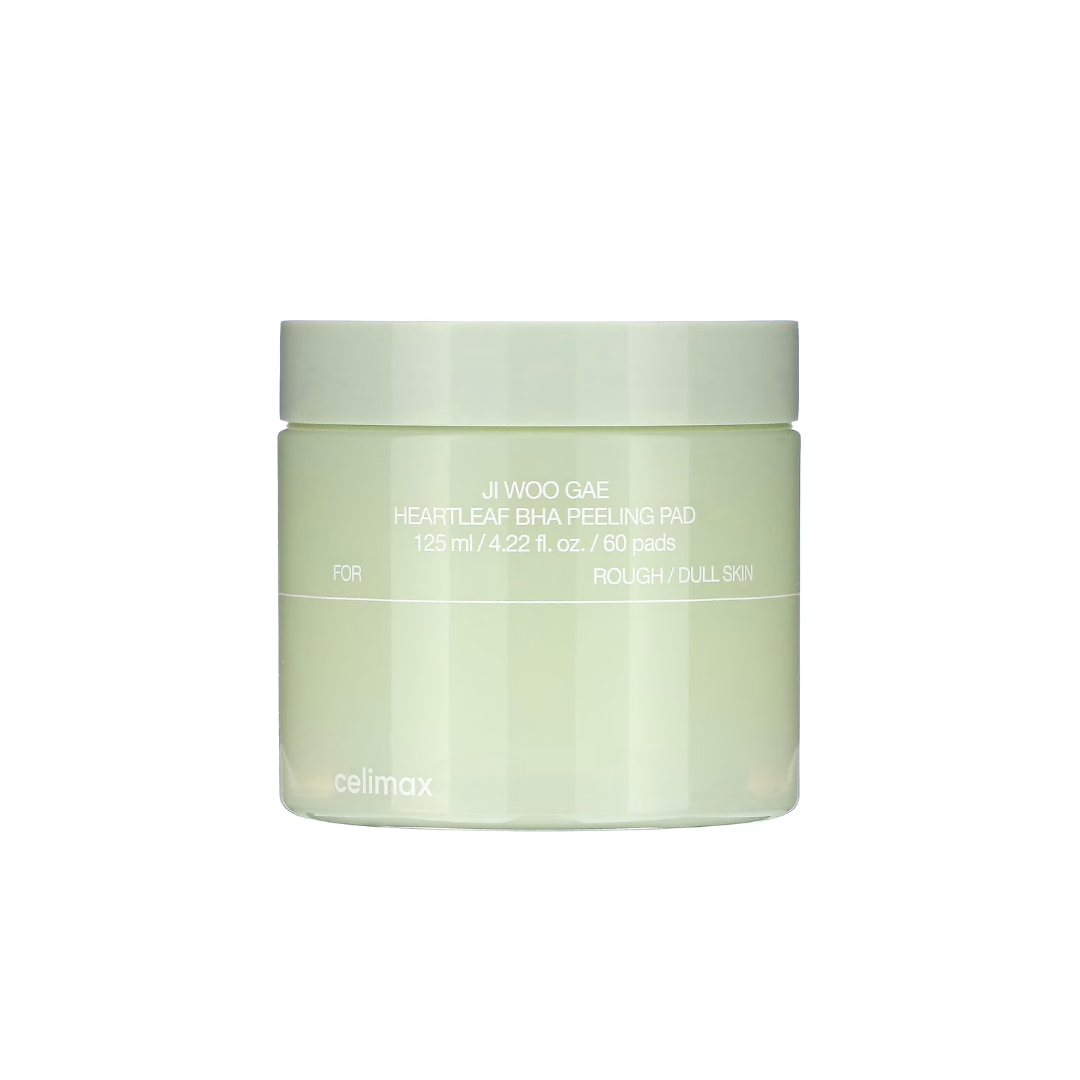 CELIMAX Ji Woo Gae Heartleaf BHA Peeling Pad is a gentle exfoliating pad designed to smooth and clarify the skin. Formulated with Betaine Salicylate (BHA), it helps remove dead skin cells and unclog pores, while Heartleaf Extract, Tea Tree, and Green Tea Water calm and refresh the skin. Enriched with Sodium Hyaluronate and Centella actives, these pads provide hydration and soothing care, leaving skin soft, clear, and balanced with every swipe.