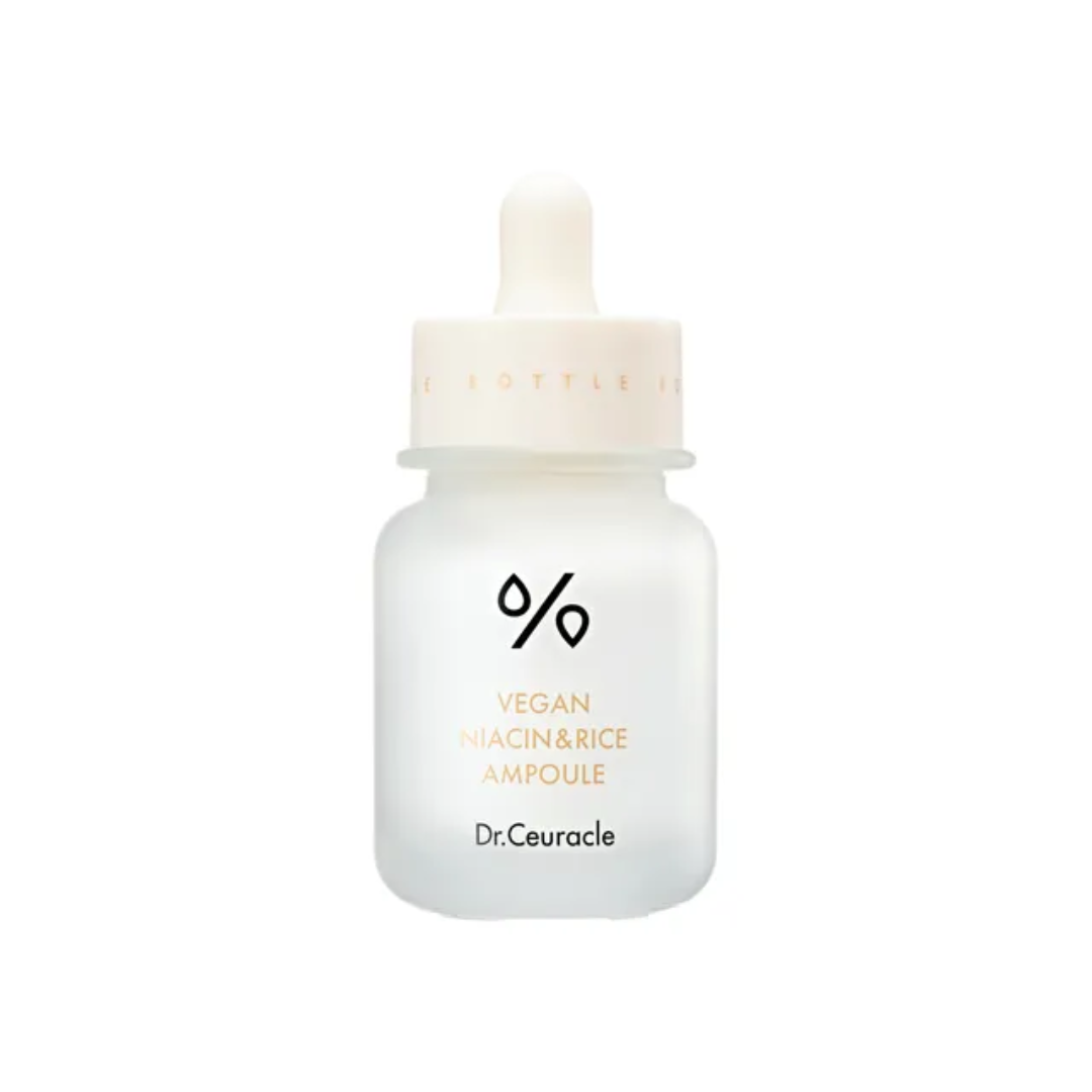 DR. CEURACLE Vegan Niacin & Rice Ampoule is a brightening and hydrating serum designed to improve skin tone and texture. Formulated with Niacinamide and Rice Extract, this ampoule helps to reduce the appearance of dark spots and uneven skin tone while deeply nourishing the skin. The lightweight formula is enriched with Panthenol and Sodium Hyaluronate to provide long-lasting hydration, leaving the skin plump and radiant. Ideal for those looking to brighten dull complexions and achieve a glowing, even-to