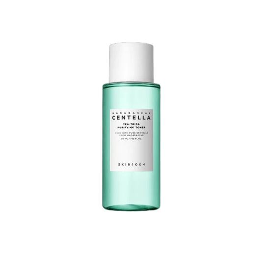 SKIN1004 Madagascar Centella Tea-Trica Purifying Toner is a refreshing and clarifying toner designed to soothe and balance the skin. It features 12% Tea Tree Leaf Water and 9.8% Centella Asiatica Extract to calm irritation and reduce redness while promoting a healthy skin barrier. Infused with Salicylic Acid, it gently exfoliates and helps unclog pores, making it ideal for acne-prone and sensitive skin. With added Lavender Extract and Castanea Crenata Shell Extract, it nourishes and refreshes, leaving your