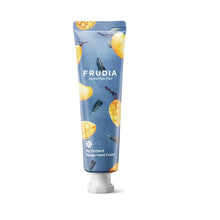 Load image into Gallery viewer, FRUDIA My Orchard Mango Hand Cream is a rich yet fast-absorbing hand cream that deeply hydrates and softens dry hands. Infused with Mango Seed Oil and a blend of fruit extracts including Citrus, Grape Seed, and Apricot Kernel Oil, it helps restore moisture and protect the skin from dryness. Shea Butter, Squalane, and Panthenol work together to nourish and smooth rough texture, while a light mango scent adds a fruity, uplifting finish. Perfect for daily use, this cream leaves hands feeling silky, refreshed, 